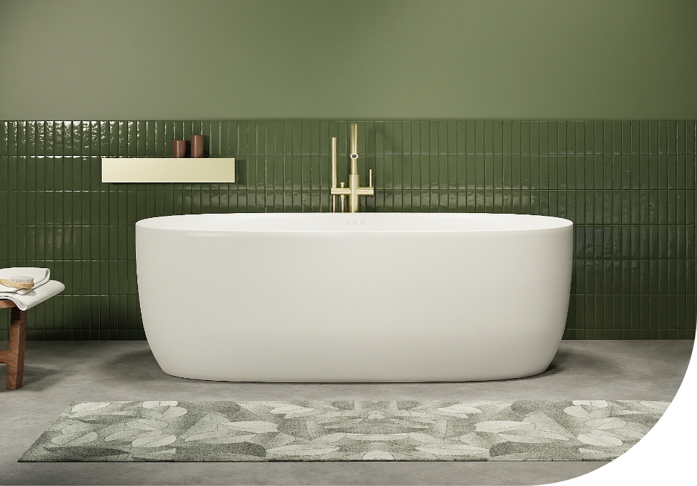 Baignoire îlot minimaliste de x²o salles de bains dans une salle de bains verte avec carreaux muraux brillants. La baignoire repose sur un sol aspect béton et est associée à une robinetterie dorée et un tapis vert doux.