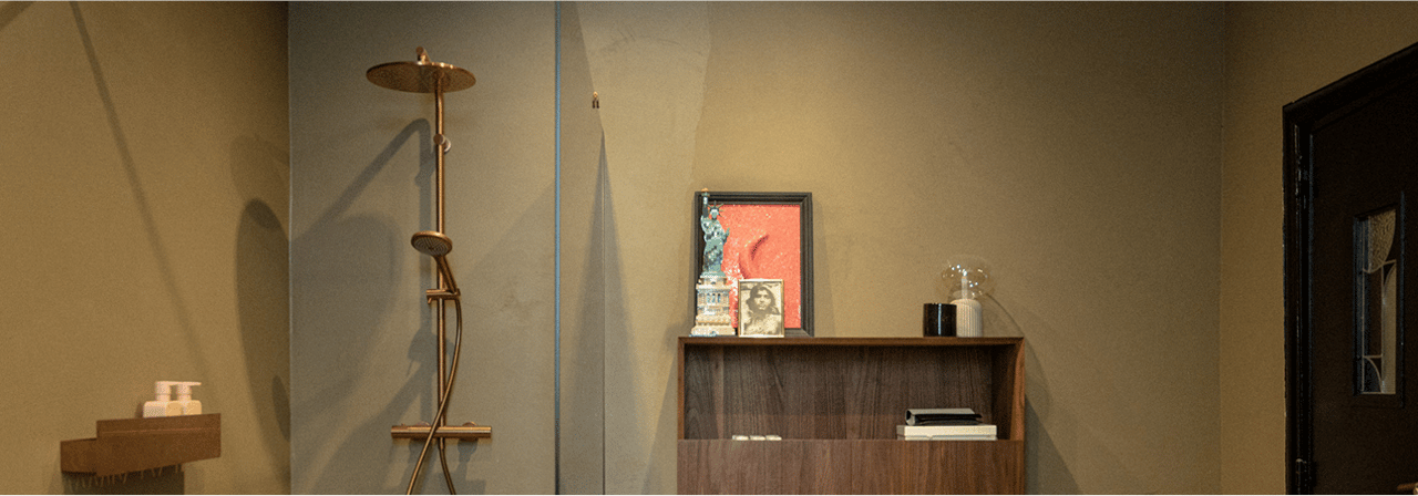 Inloopdouche met regendouche en houten kastje met persoonlijke decoratie.