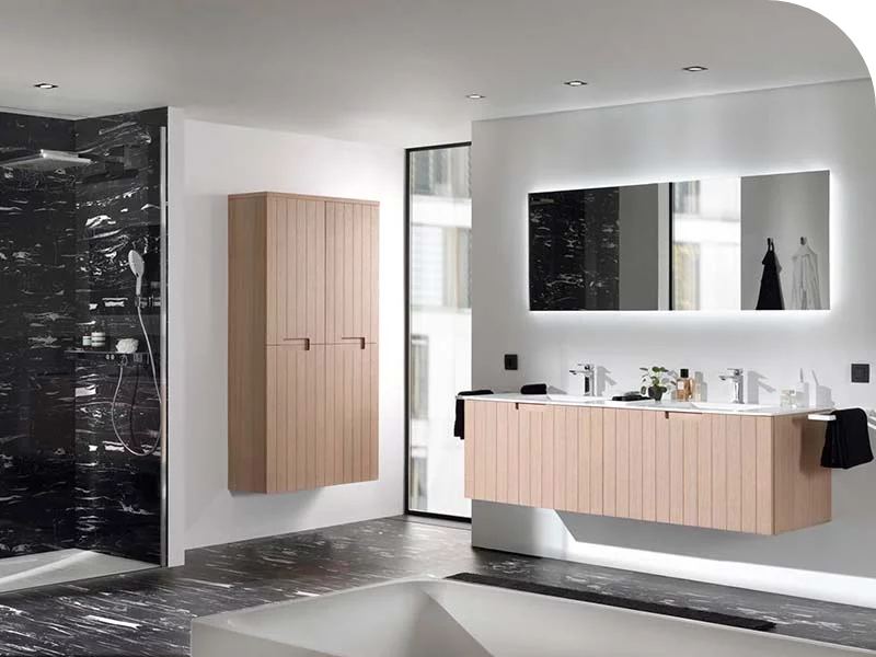 Badkamer met houten wastafelmeubel, dubbele wastafel, moderne kranen, grote verlichte spiegel en een donkere marmeren douchewand.