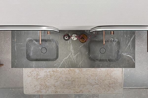 Plan de lavabo en marbre gris avec deux lavabos rectangulaires et des robinets de couleur cuivre, vu du dessus.