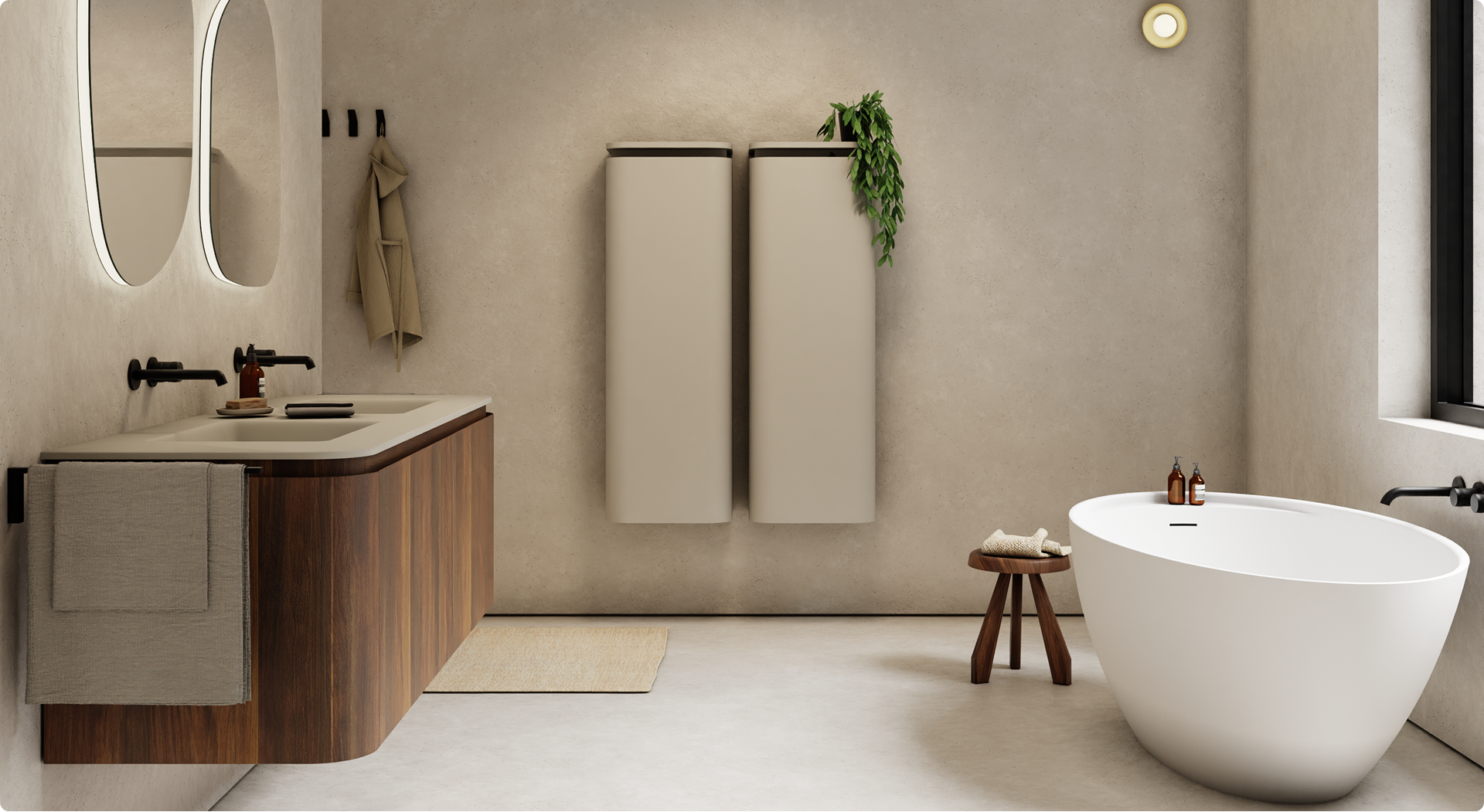 Minimalistische x²o badkamers met strakke lijnen en warme aardetinten. Links een houten meubel met dubbele wastafel, matzwarte kranen en verlichte spiegels. Rechts een ovale vrijstaande badkuip met houten krukje en verzorgingsproducten ernaast.