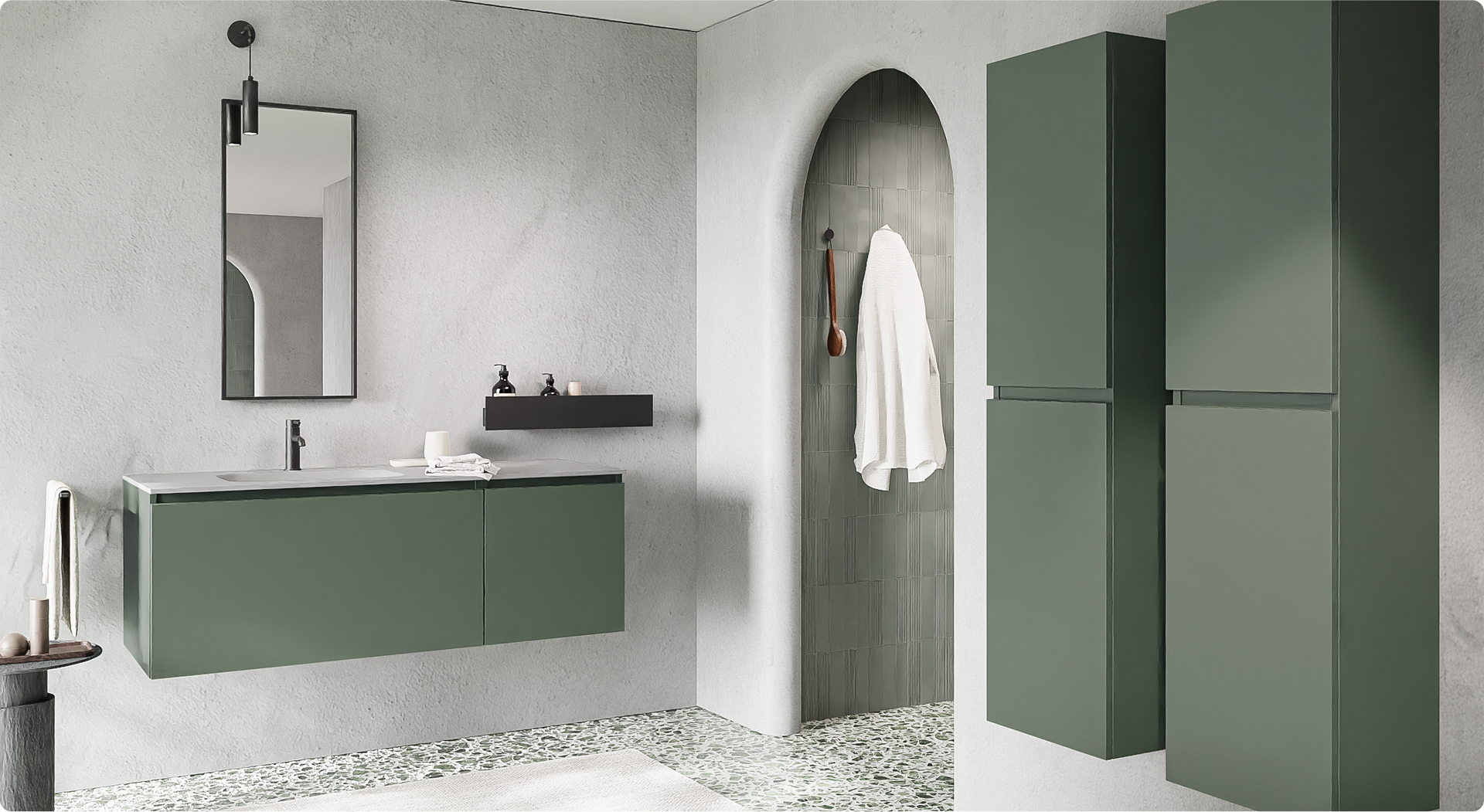 Design x²o badkamers met groene wandmeubels en witte wastafel, zwarte accenten en accessoires. Aan de rechterzijde twee hoge kolomkasten in dezelfde groentint. De vloer heeft een terrazzo-look en er is een inloopdouche met gewelfd toegangspoortje.