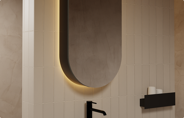 Ovaler Spiegelschrank von x²o Badezimmer mit integrierter Beleuchtung und schwarzem Wasserhahn vor beiger Fliesenwand.
