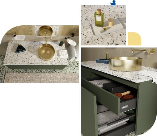 Groene badkamermeubelset met terrazzo werkblad, gouden kraan en waskom, open lades met handdoeken en verzorgingsproducten.