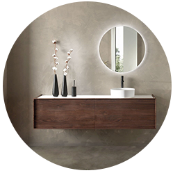 Zwevend badkamermeubel van donker hout met een witte wastafel en ronde spiegel in een moderne badkamer.