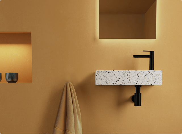 Salle de bains tendance en jaune ocre, avec vasque en terrazzo et robinet noir. Une option chaleureuse dans les couleurs tendance 2026 chez X²O Salle de bains.