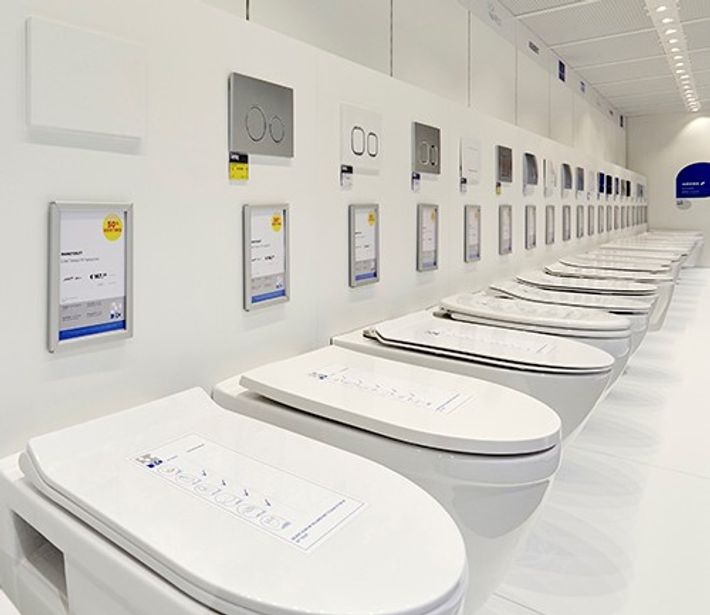 : Übersicht einer Showroom-Wand mit mehreren wandhängenden Toiletten und passenden Betätigungsplatten in einer Reihe. Die Aufnahme zeigt die große Auswahl an Toilettenlösungen bei x²o Badezimmer.