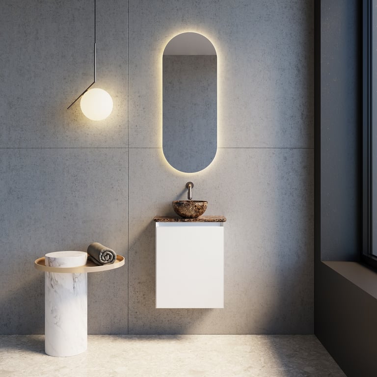 Minimalistisch badkamermeubel met marmeren wastafel, ovalen spiegel met verlichting en witte kast.