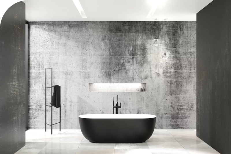 Vrijstaand zwart-wit bad in een moderne badkamer met betonlook wand, minimalistisch en luxueus ontwerp.