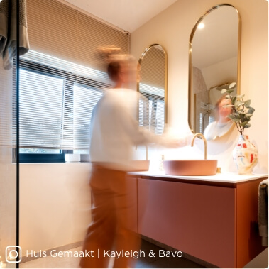 Salle de bains moderne avec meuble vasque rose, vasque ronde et accents dorés pour une ambiance chaleureuse