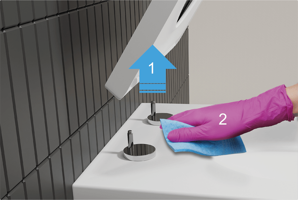 Close-up van een toiletbril die omhoog wordt gehaald (1) en een hand met roze handschoen die het oppervlak schoonmaakt met een doekje (2). Een duidelijke uitleg van de easy clean-functie van x²o badkamers.